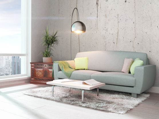 von Malerei renoviertes Wohnzimmer mit grünem Sofa in Kufstein